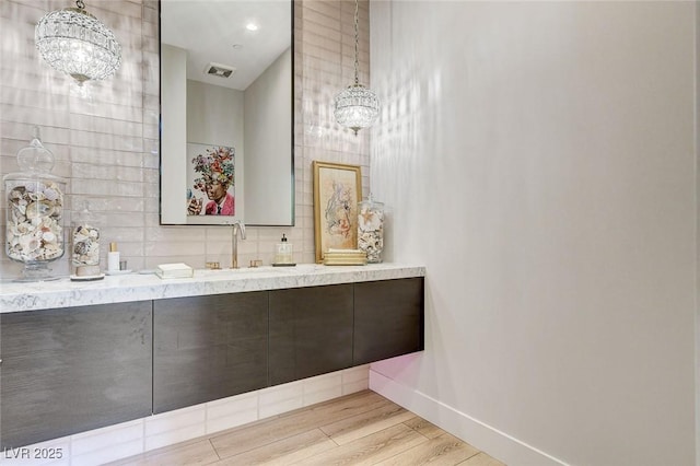527 Serenity Point Dr, Henderson, NV 89012 - bathroom with a chandelier, wood finished floors, and vanity