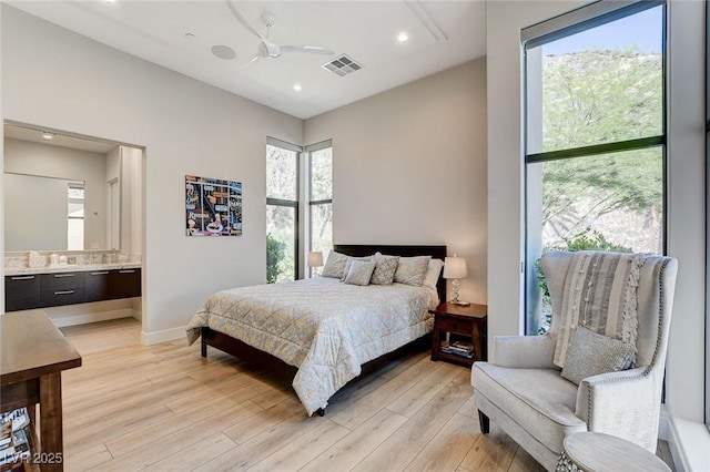 527 Serenity Point Dr, Henderson, NV 89012 - bedroom featuring light wood-style floors, recessed lighting, and ensuite bathroom