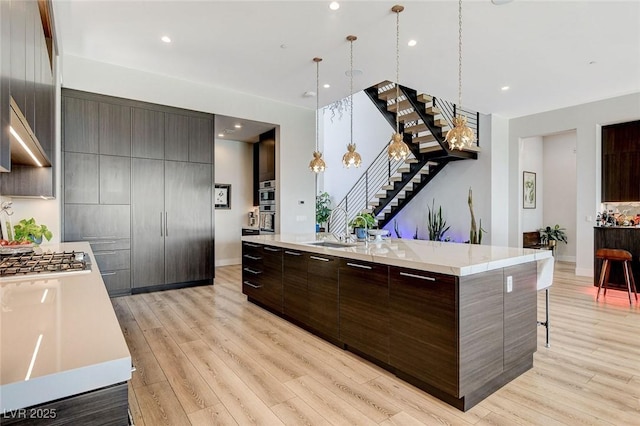 527 Serenity Point Dr, Henderson, NV 89012 - kitchen featuring modern cabinets, light countertops, stainless steel gas cooktop, and recessed lighting