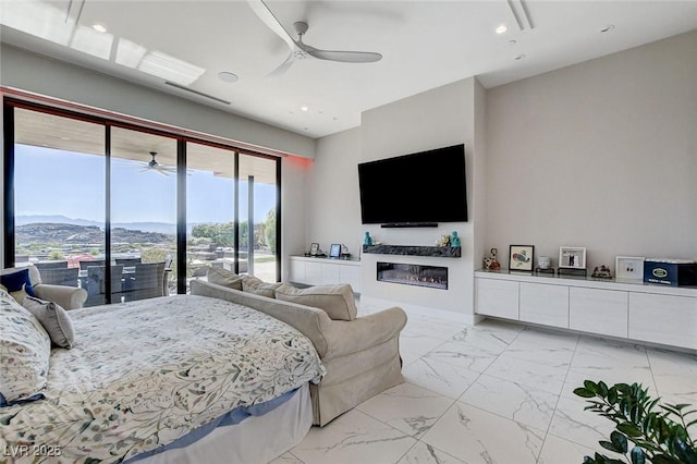 527 Serenity Point Dr, Henderson, NV 89012 - bedroom with access to exterior, light marble finish flooring, a glass covered fireplace, recessed lighting, and ceiling fan