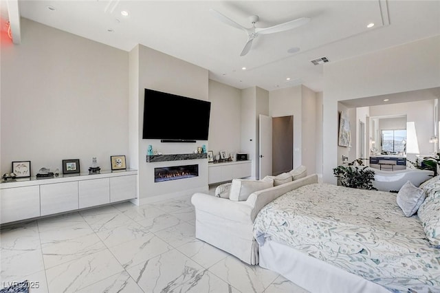 527 Serenity Point Dr, Henderson, NV 89012 - bedroom with light marble finish floors, a glass covered fireplace, recessed lighting, and ceiling fan
