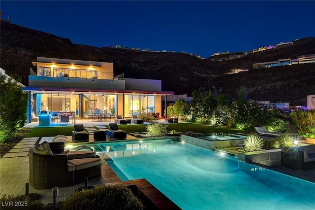 527 Serenity Point Dr, Henderson, NV 89012 - pool at twilight with an in-ground hot tub, a patio area, and an infinity pool