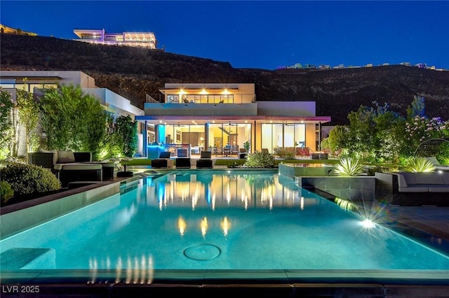 527 Serenity Point Dr, Henderson, NV 89012 - pool at twilight featuring an outdoor hangout area, an infinity pool, and a patio area