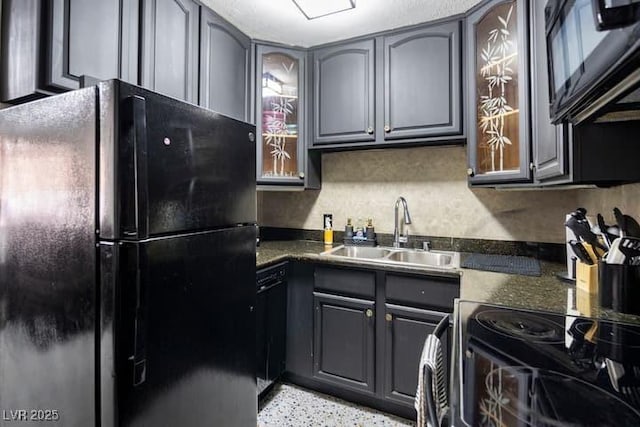 4955 Jeffreys St Unit 605, Las Vegas, NV 89119 - kitchen with black appliances, dark countertops, gray cabinets, and glass insert cabinets