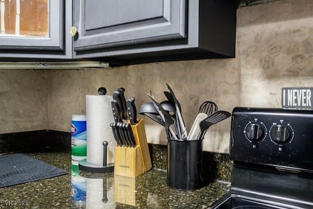 4955 Jeffreys St Unit 605, Las Vegas, NV 89119 - kitchen view of decorative backsplash, dark stone counters, and range with electric stovetop