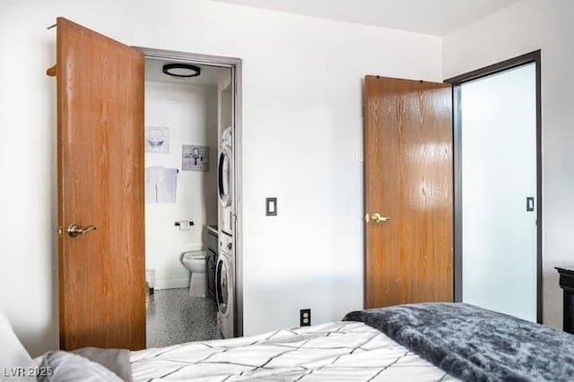 4955 Jeffreys St Unit 605, Las Vegas, NV 89119 - bedroom with stacked washer and clothes dryer and ensuite bath