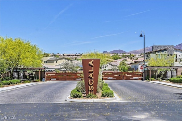 2170 Monte Bianco Pl, Henderson, NV 89044 - view of asphalt road with curbs, street lights, a gated entry, a residential view, and a mountain view