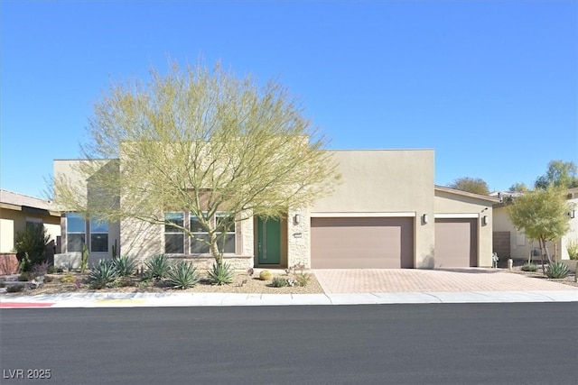 2170 Monte Bianco Pl, Henderson, NV 89044 - view of front of house featuring a garage, decorative driveway, stucco siding, and stone siding