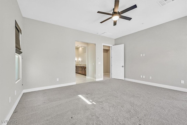 2170 Monte Bianco Pl, Henderson, NV 89044 - unfurnished bedroom featuring light colored carpet, connected bathroom, and a ceiling fan