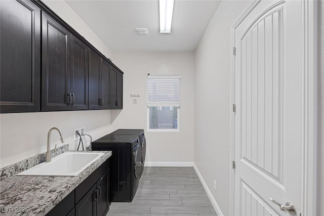274 Chartan Ave, Las Vegas, NV 89183 - laundry room featuring cabinet space, washing machine and clothes dryer, and light wood finished floors