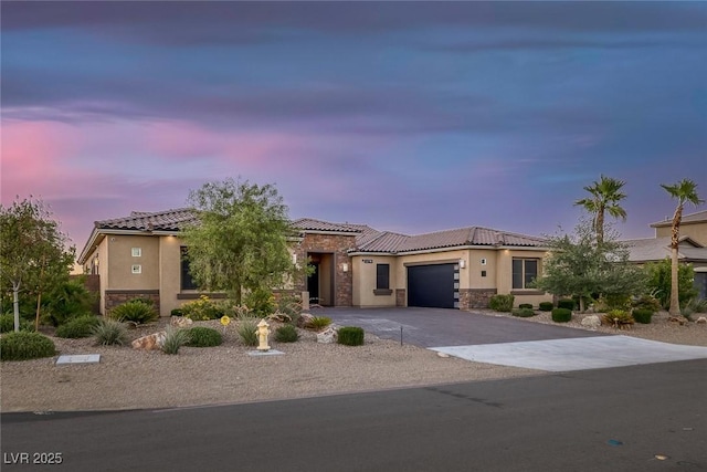 274 Chartan Ave, Las Vegas, NV 89183 - view of front of home featuring stone siding, stucco siding, an attached garage, and a tiled roof