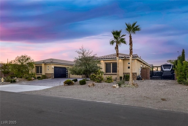 274 Chartan Ave, Las Vegas, NV 89183 - mediterranean / spanish home featuring stucco siding, a tile roof, driveway, a garage, and stone siding