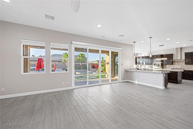 274 Chartan Ave, Las Vegas, NV 89183 - unfurnished living room with light wood-style floors and recessed lighting