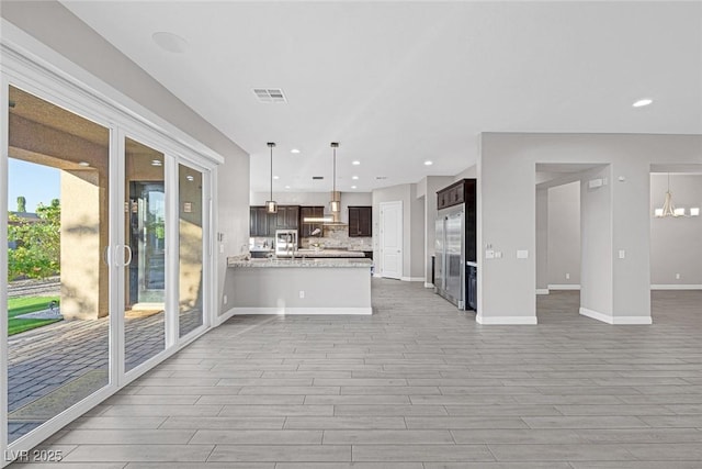 274 Chartan Ave, Las Vegas, NV 89183 - kitchen with open floor plan, a peninsula, light wood-style flooring, dark brown cabinetry, and recessed lighting