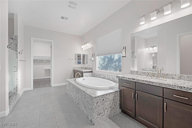 274 Chartan Ave, Las Vegas, NV 89183 - bathroom with a stall shower, a garden tub, two vanities, and tile patterned floors