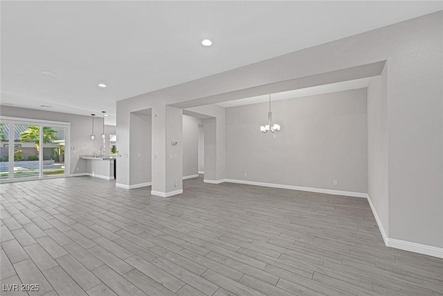 274 Chartan Ave, Las Vegas, NV 89183 - unfurnished living room with a chandelier, wood finished floors, and recessed lighting