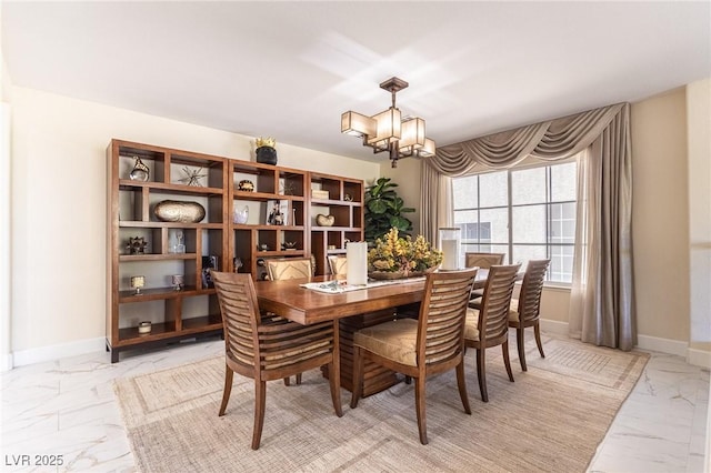 11005 Inverlochy Ct, Las Vegas, NV 89141 - dining space featuring light marble finish floors and a chandelier