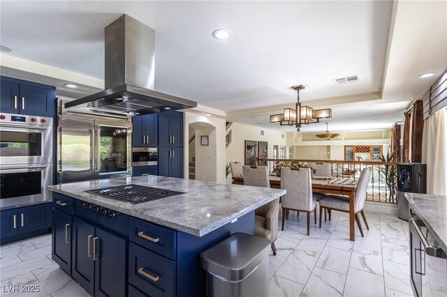11005 Inverlochy Ct, Las Vegas, NV 89141 - kitchen featuring appliances with stainless steel finishes, island range hood, blue cabinets, and recessed lighting