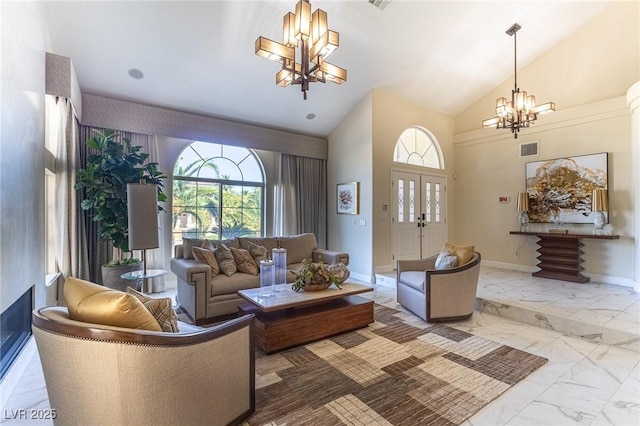 11005 Inverlochy Ct, Las Vegas, NV 89141 - living room featuring a chandelier, marble look tiles, high vaulted ceiling, and a fireplace