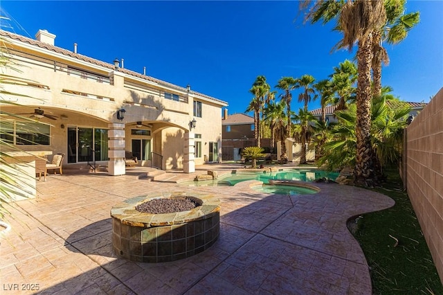 11005 Inverlochy Ct, Las Vegas, NV 89141 - fenced backyard featuring ceiling fan, a patio, a fire pit, and a pool with connected hot tub