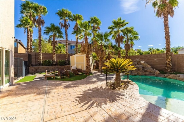 11005 Inverlochy Ct, Las Vegas, NV 89141 - view of pool featuring a storage unit, a fenced backyard, and a patio area