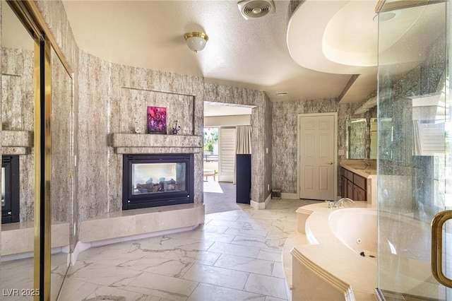 11005 Inverlochy Ct, Las Vegas, NV 89141 - bathroom featuring a multi sided fireplace, marble look tiles, a shower stall, a jetted tub, and vanity