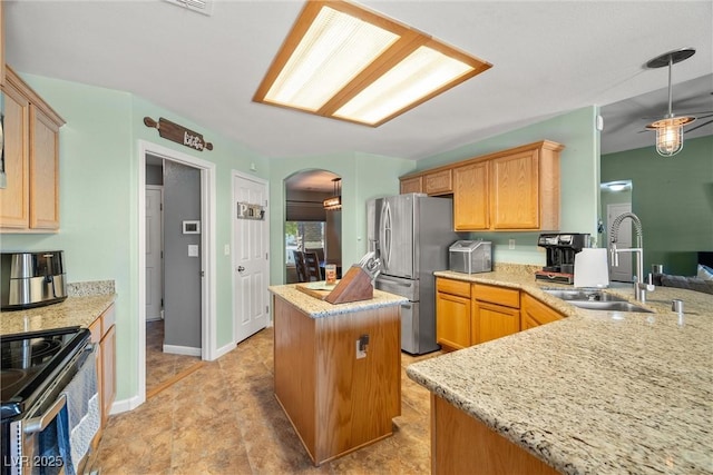 231 Bristle Cone, Pahrump, NV 89048 - kitchen featuring stainless steel appliances, a kitchen island, arched walkways, light stone counters, and hanging light fixtures