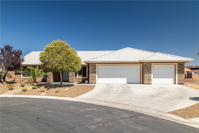 231 Bristle Cone, Pahrump, NV 89048 - view of front of home featuring stone siding, a garage, concrete driveway, and a tile roof
