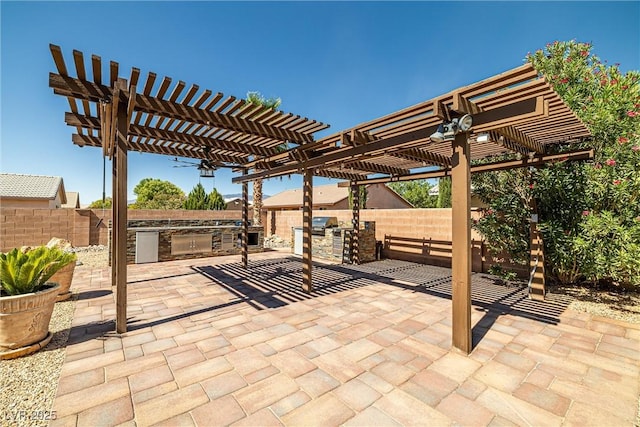 231 Bristle Cone, Pahrump, NV 89048 - fenced backyard featuring exterior kitchen, a patio, and a pergola