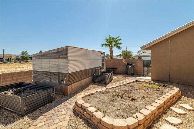 231 Bristle Cone, Pahrump, NV 89048 - view of yard with a garden and a gate