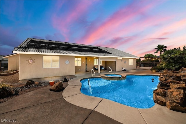 231 Bristle Cone, Pahrump, NV 89048 - pool at dusk featuring a patio area and a pool with connected hot tub