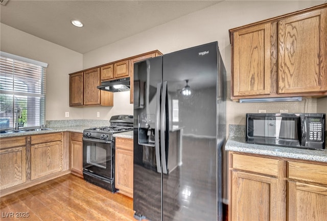 3757 Via Geneva, Henderson, NV 89052 - kitchen featuring black appliances, under cabinet range hood, wood finished floors, recessed lighting, and light stone countertops
