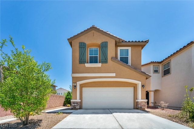 3757 Via Geneva, Henderson, NV 89052 - mediterranean / spanish house featuring an attached garage, stucco siding, concrete driveway, a tiled roof, and stone siding