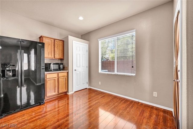 3757 Via Geneva, Henderson, NV 89052 - kitchen with black appliances, wood finished floors, brown cabinets, and recessed lighting