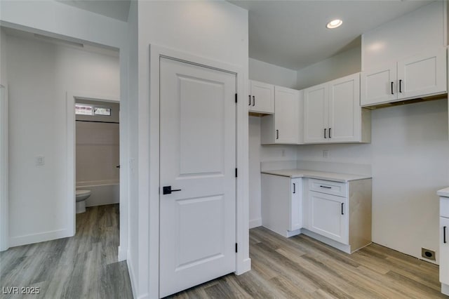 365 N 16th St, Las Vegas, NV 89101 - kitchen featuring white cabinetry, light wood-style flooring, light countertops, and recessed lighting