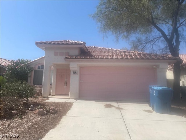 8151 Chambersberg St, Las Vegas, NV 89147 - mediterranean / spanish-style house with an attached garage, a tile roof, concrete driveway, and stucco siding