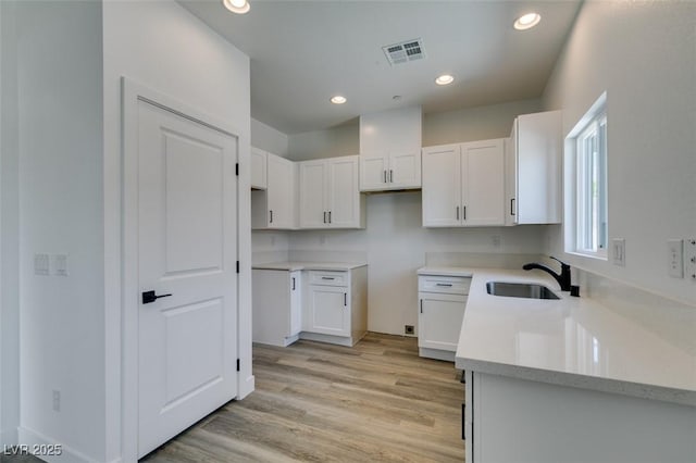 367 N 16th St, Las Vegas, NV 89101 - kitchen featuring white cabinetry, light wood finished floors, and recessed lighting