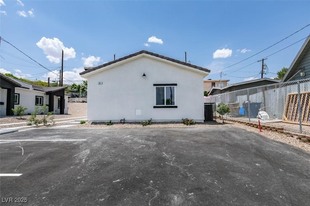 367 N 16th St, Las Vegas, NV 89101 - view of property exterior with stucco siding, a tiled roof, and uncovered parking