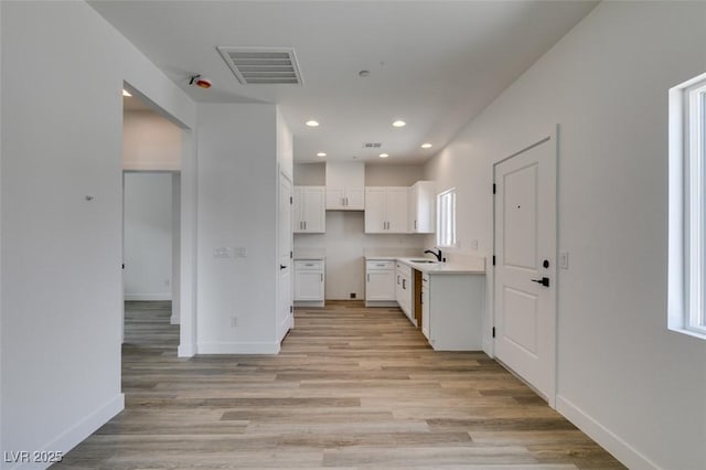 367 N 16th St, Las Vegas, NV 89101 - kitchen featuring white cabinetry, light wood-type flooring, recessed lighting, and light countertops