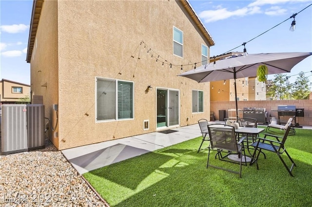 8937 Pelican Point St, Las Vegas, NV 89178 - rear view of house with stucco siding, a patio, and exterior kitchen