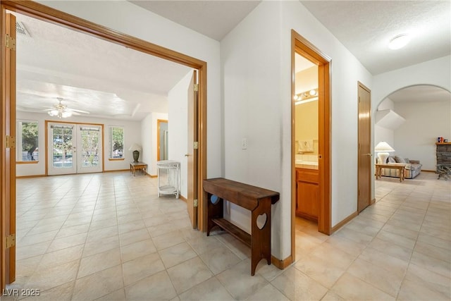 2040 Tucuman Ave, Pahrump, NV 89048 - hall featuring light tile patterned floors and arched walkways