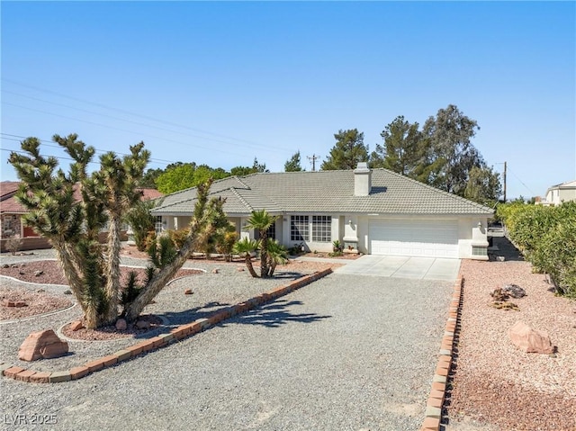 2040 Tucuman Ave, Pahrump, NV 89048 - ranch-style home with a tile roof, concrete driveway, a chimney, a garage, and stucco siding
