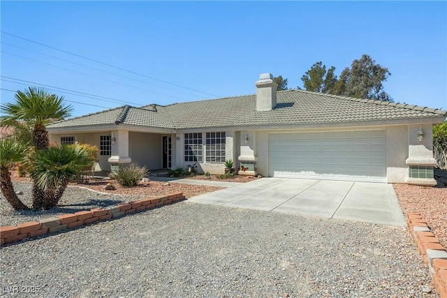 2040 Tucuman Ave, Pahrump, NV 89048 - single story home with concrete driveway, a tile roof, an attached garage, stucco siding, and a chimney