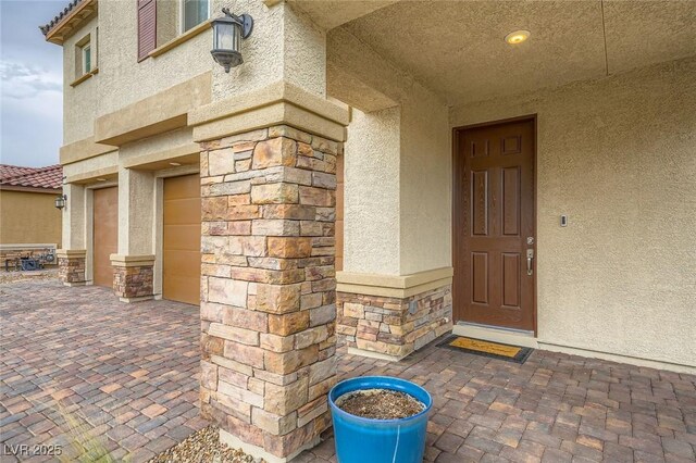 5990 Viscaya Grove St, Las Vegas, NV 89118 - doorway to property with stucco siding and stone siding
