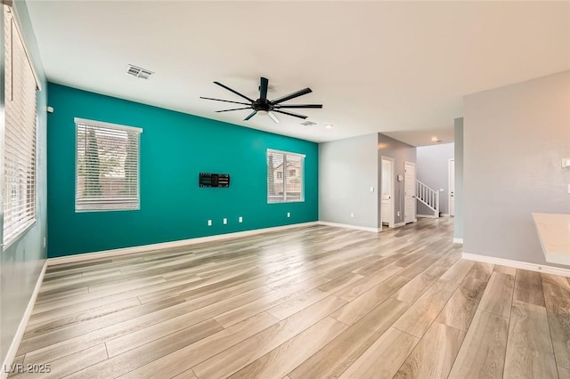 5990 Viscaya Grove St, Las Vegas, NV 89118 - unfurnished living room featuring light wood-type flooring, a ceiling fan, plenty of natural light, and stairs