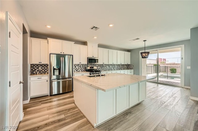 5990 Viscaya Grove St, Las Vegas, NV 89118 - kitchen featuring stainless steel appliances, light wood-style floors, decorative backsplash, and recessed lighting