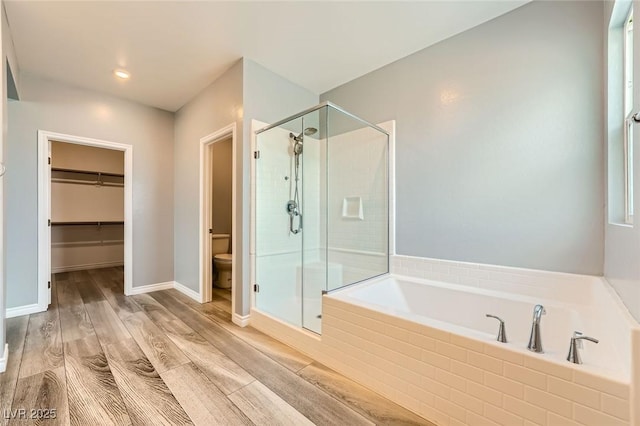 5990 Viscaya Grove St, Las Vegas, NV 89118 - bathroom featuring a stall shower, a bath, wood finished floors, a spacious closet, and recessed lighting