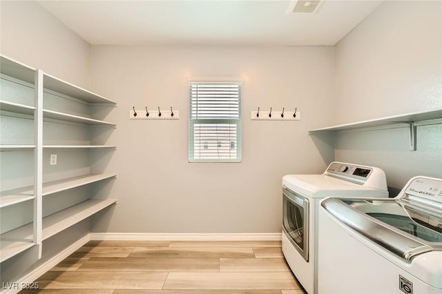 5990 Viscaya Grove St, Las Vegas, NV 89118 - laundry area with separate washer and dryer and light wood finished floors