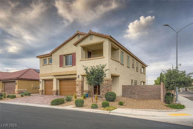 5990 Viscaya Grove St, Las Vegas, NV 89118 - view of front of property featuring stucco siding, stone siding, an attached garage, and driveway