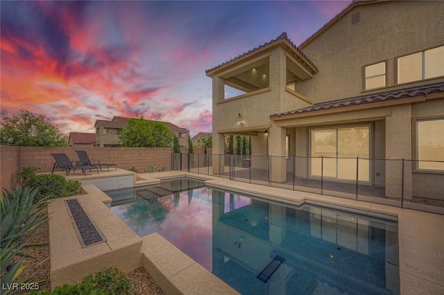 5990 Viscaya Grove St, Las Vegas, NV 89118 - pool at dusk featuring a patio and a fenced backyard